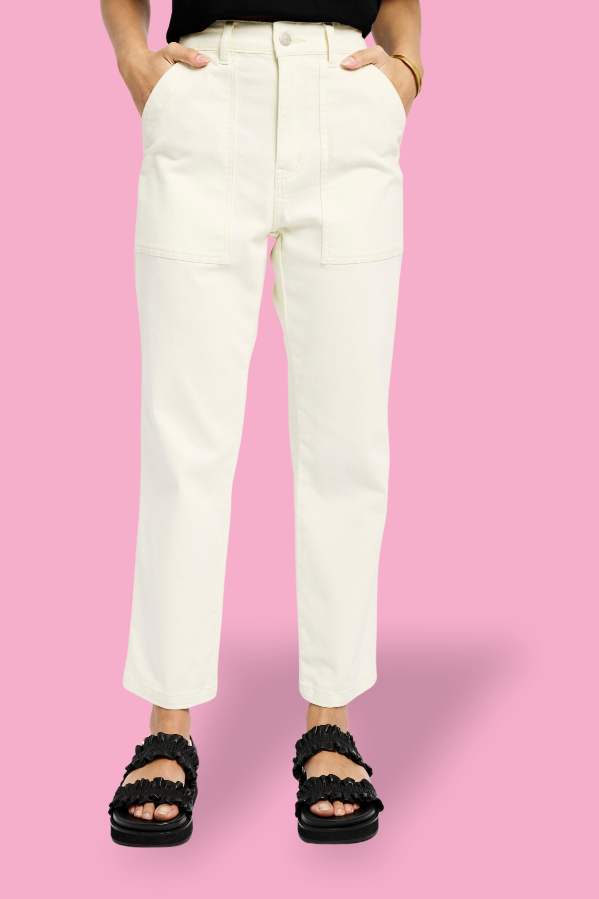 Model is wearing milk carrot leg jeans with black sandals