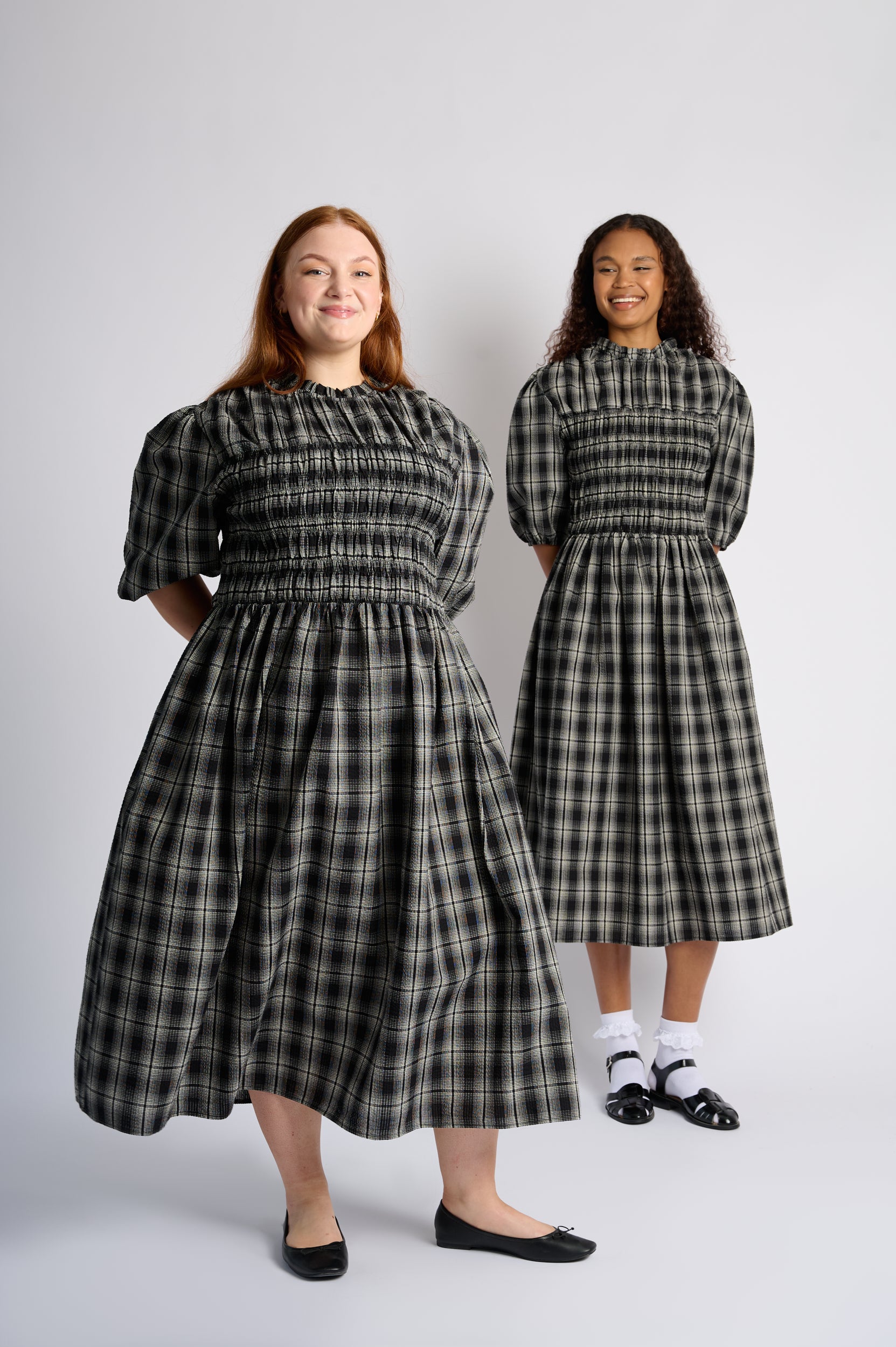 Models are wearing a black shirring cotton dress in black check with black shoes