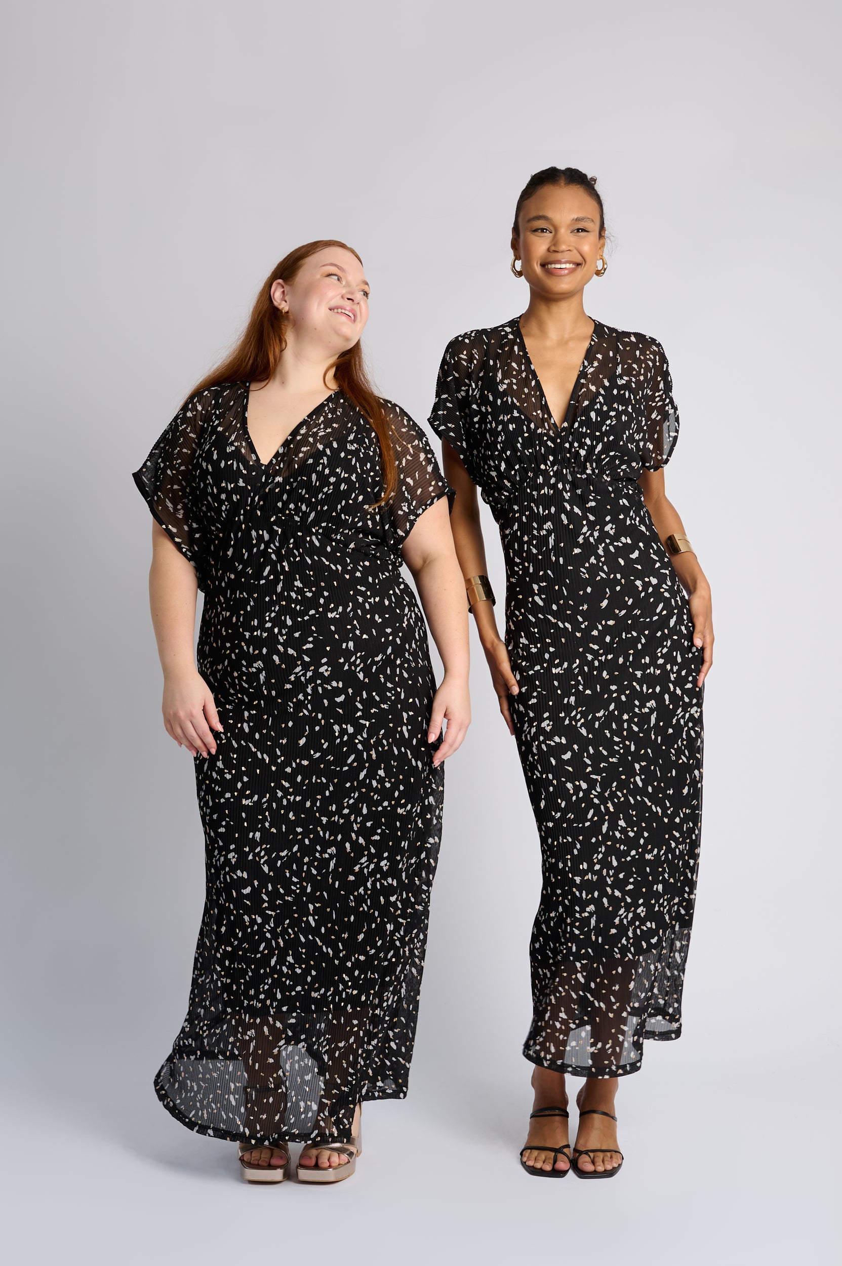 Models are wearing a black short sleeve dress with heels