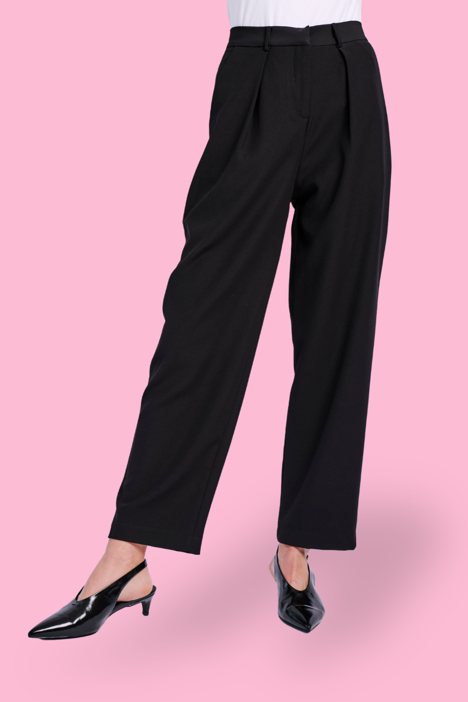Model wearing tailored black pant with black heel