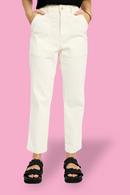 Model is wearing milk carrot leg jeans with black sandals 