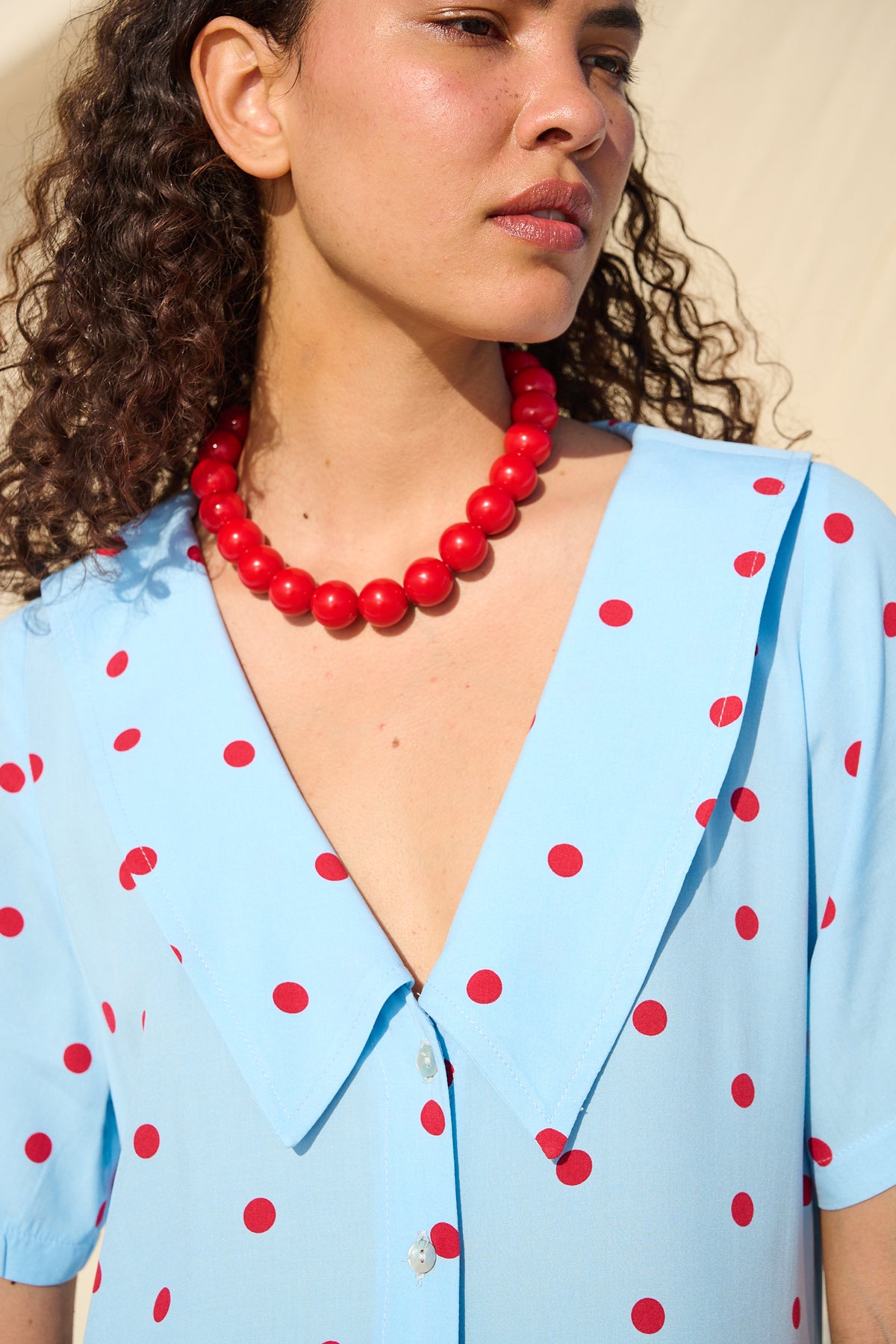 Light blue button-front maxi dress with red polka dots and a wide collar