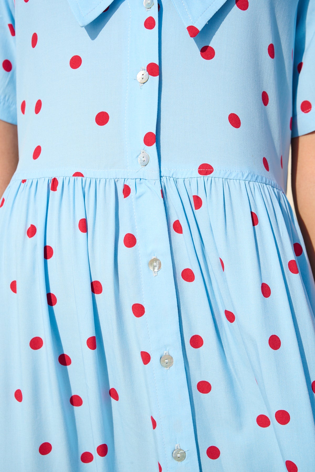 Light blue button-front maxi dress with red polka dots and a wide collar