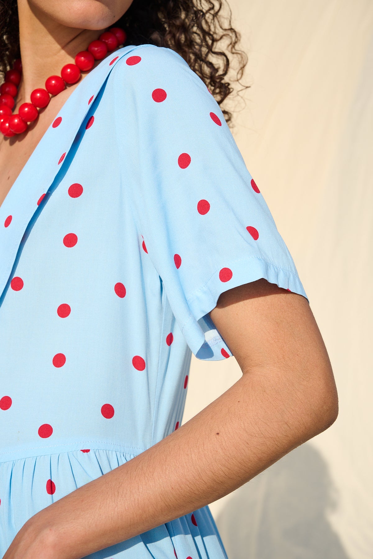 Light blue button-front maxi dress with red polka dots and a wide collar