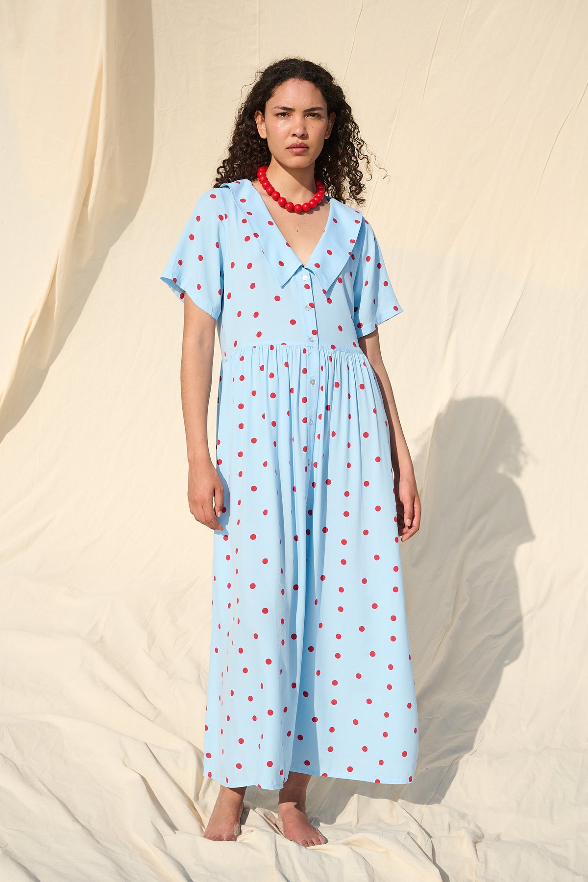 Light blue button-front maxi dress with red polka dots and a wide collar