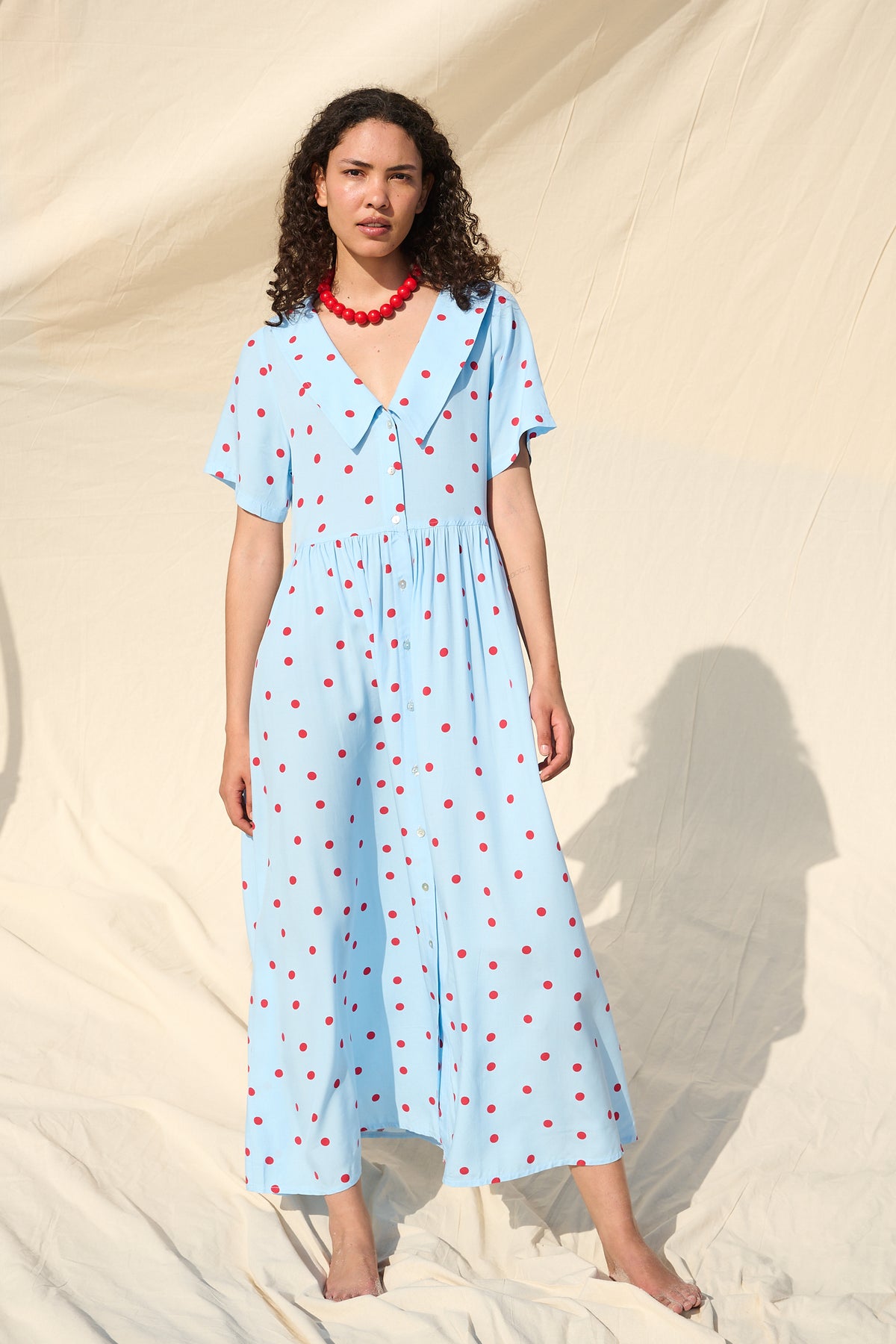 Light blue button-front maxi dress with red polka dots and a wide collar
