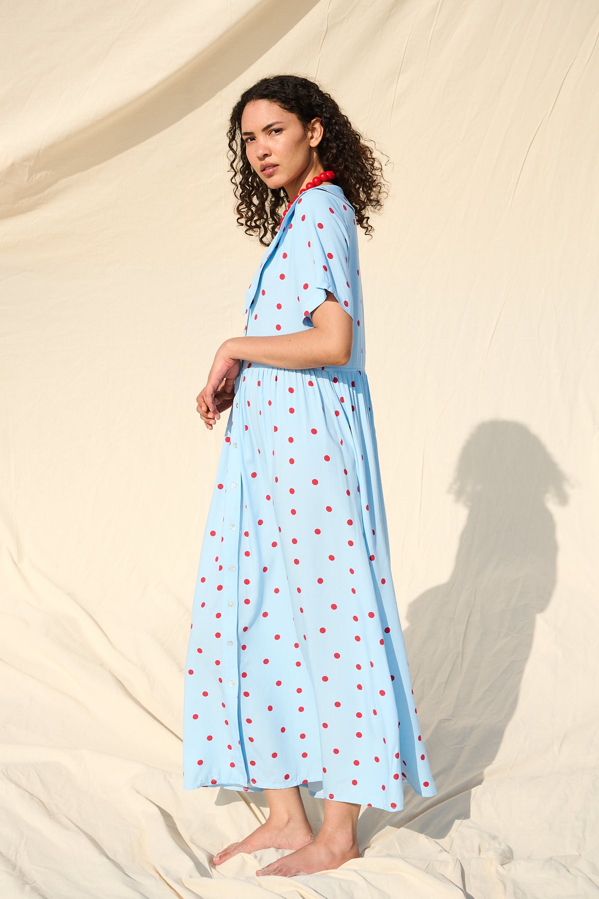 Light blue button-front maxi dress with red polka dots and a wide collar