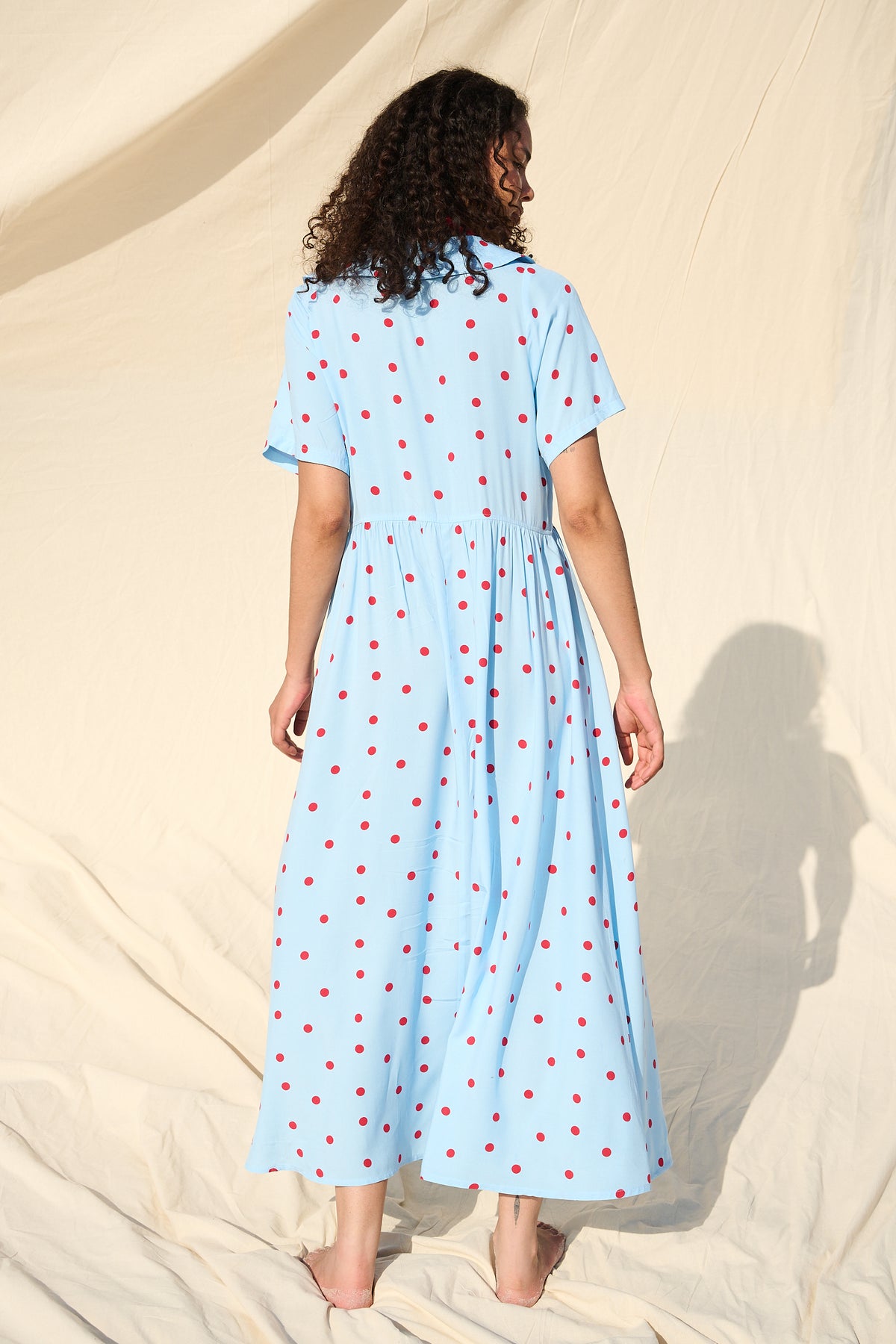 Light blue button-front maxi dress with red polka dots and a wide collar