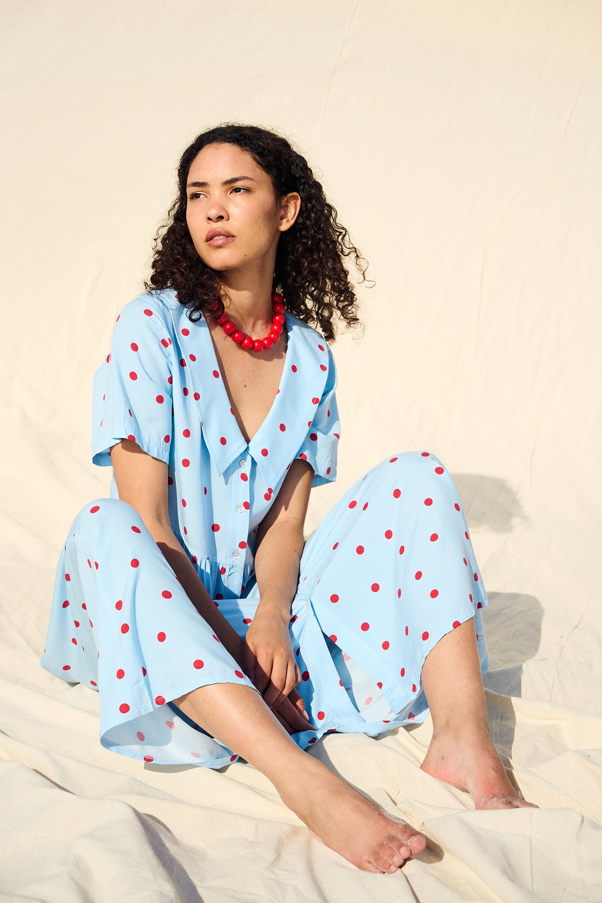 Light blue button-front maxi dress with red polka dots and a wide collar