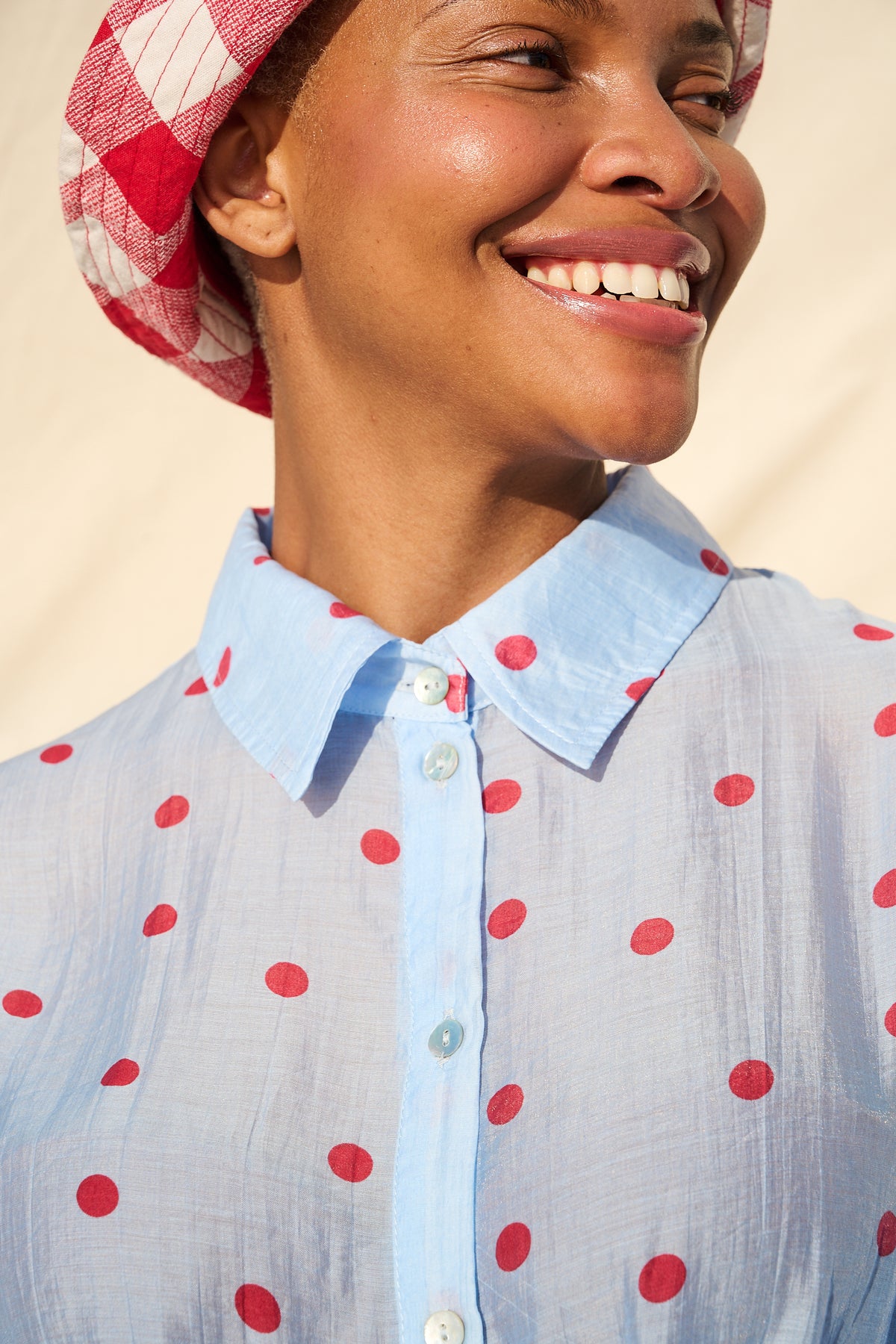 Light blue blouse with red polka dots, long sleeves and a tie waist
