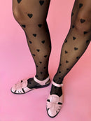 Model wearing black heart printed tights