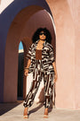 Model wearing oversized chocolate banana-print viscose short-sleeve shirt