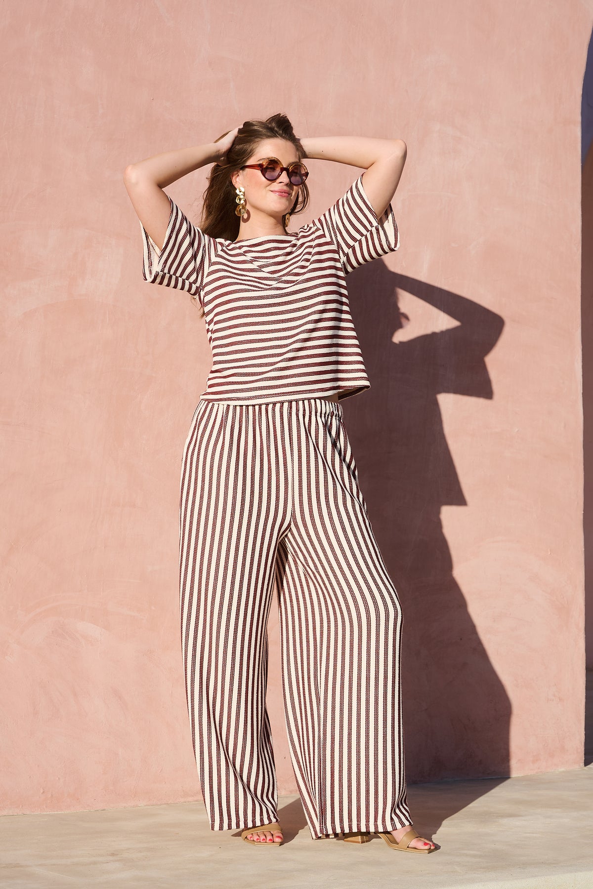 Model wearing chocolate and milk striped boat-neck knitted top
