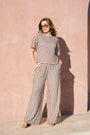 Model wearing chocolate and milk striped boat-neck knitted top