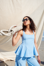 Light blue peplum top with a square neckline and wide straps