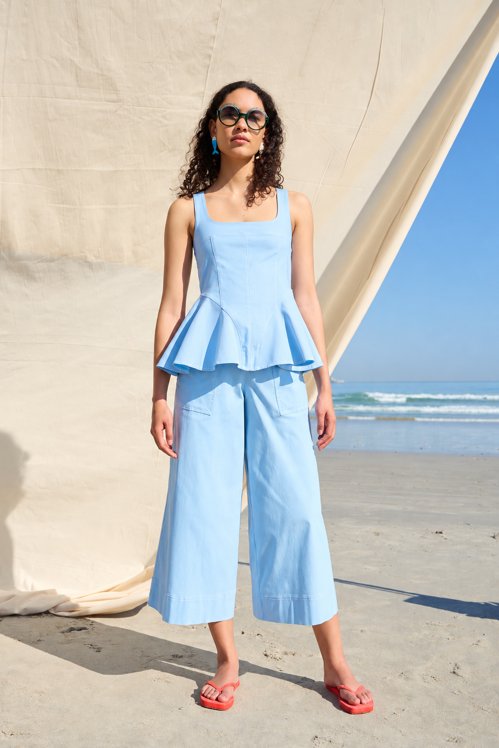 Light blue peplum top with a square neckline and wide straps