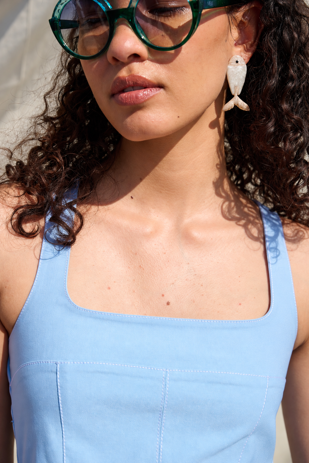Light blue peplum top with a square neckline and wide straps