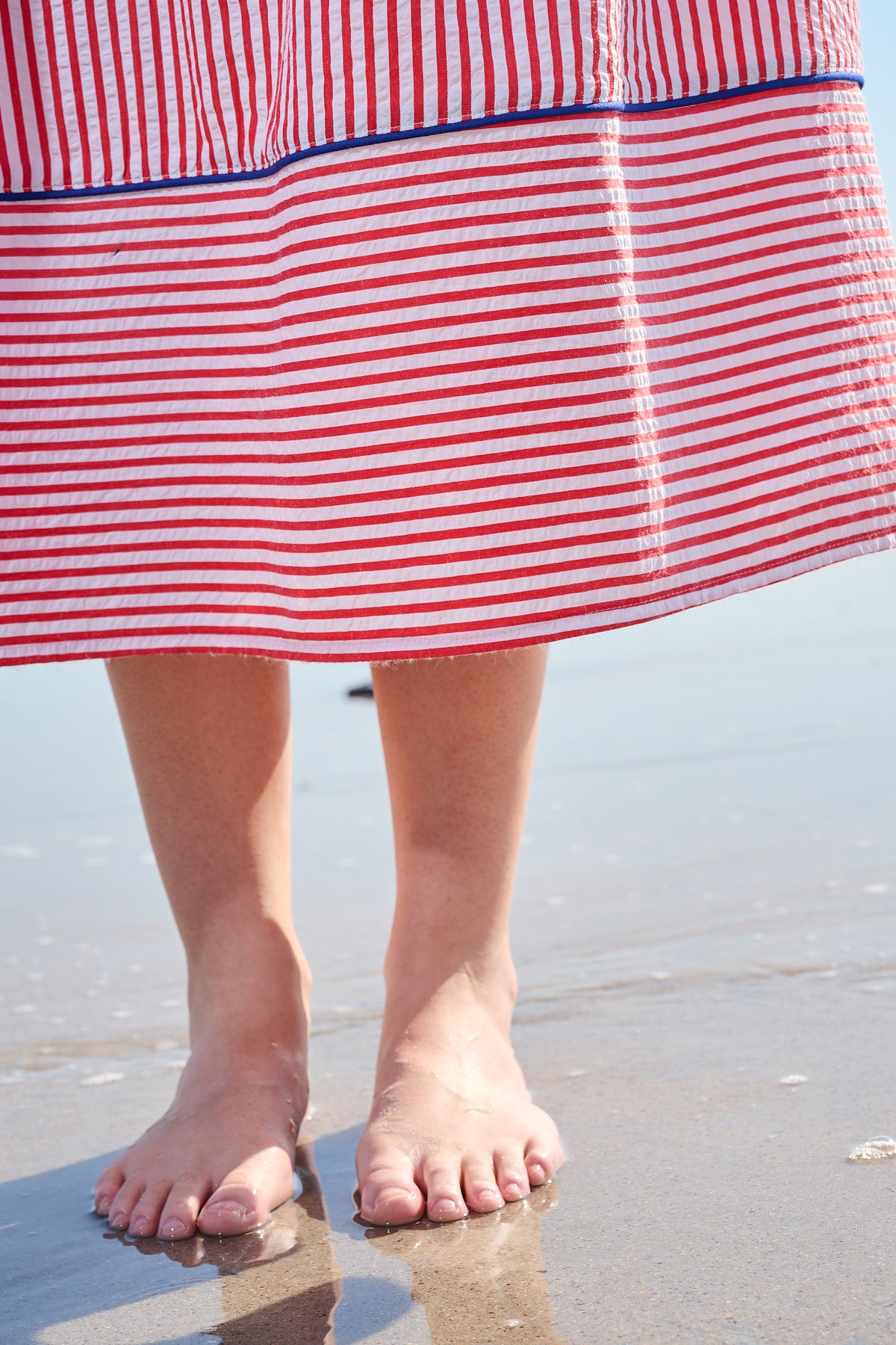 Red and white striped midi dress with blue embroidery and puff sleeves