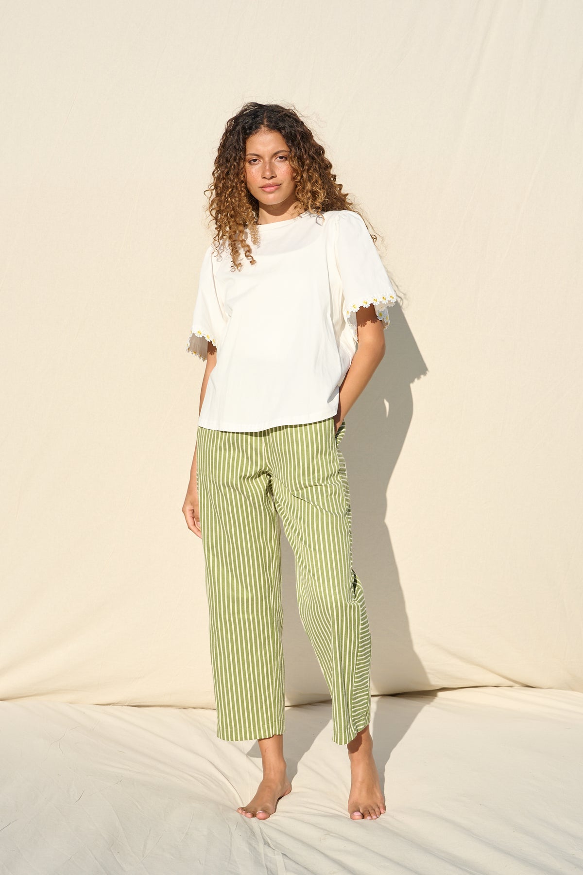 100% cotton white T-shirt with delicate yellow daisy trim sleeves