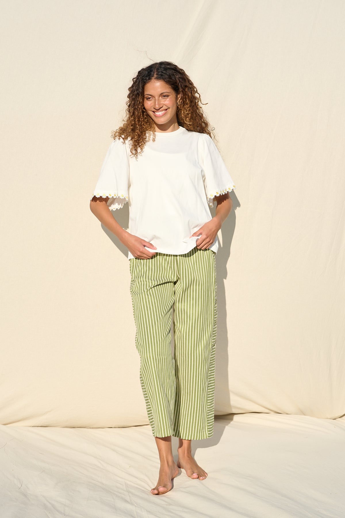100% cotton white T-shirt with delicate yellow daisy trim sleeves