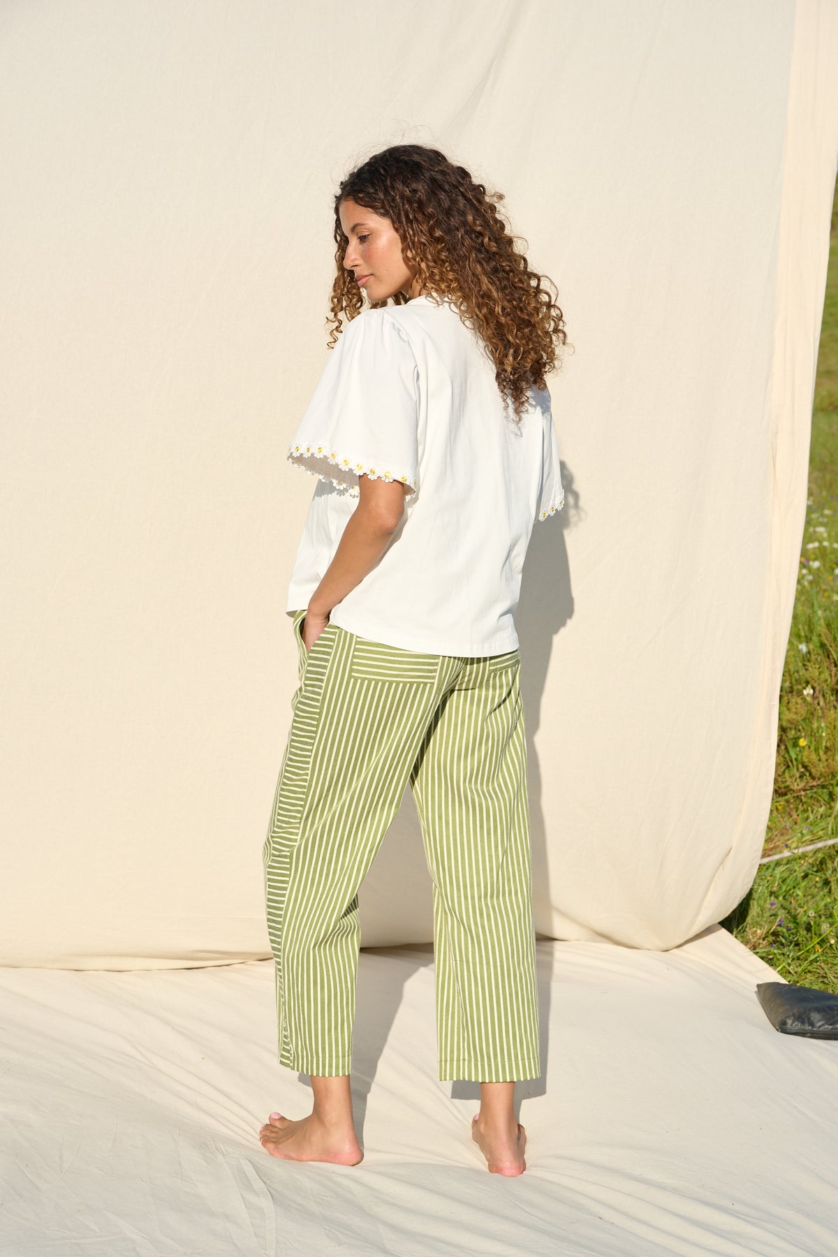 100% cotton white T-shirt with delicate yellow daisy trim sleeves