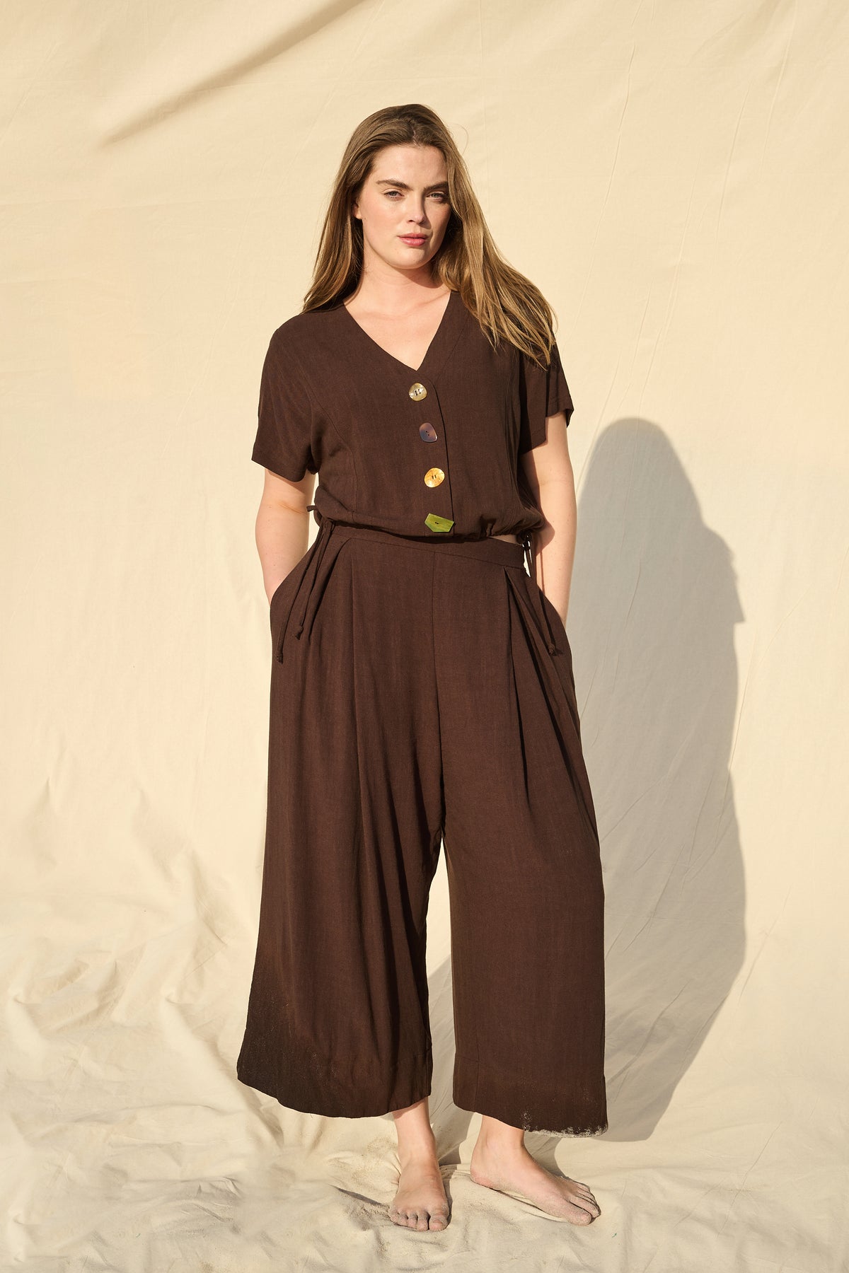 Model wearing chocolate rayon-linen top with drawstring waist