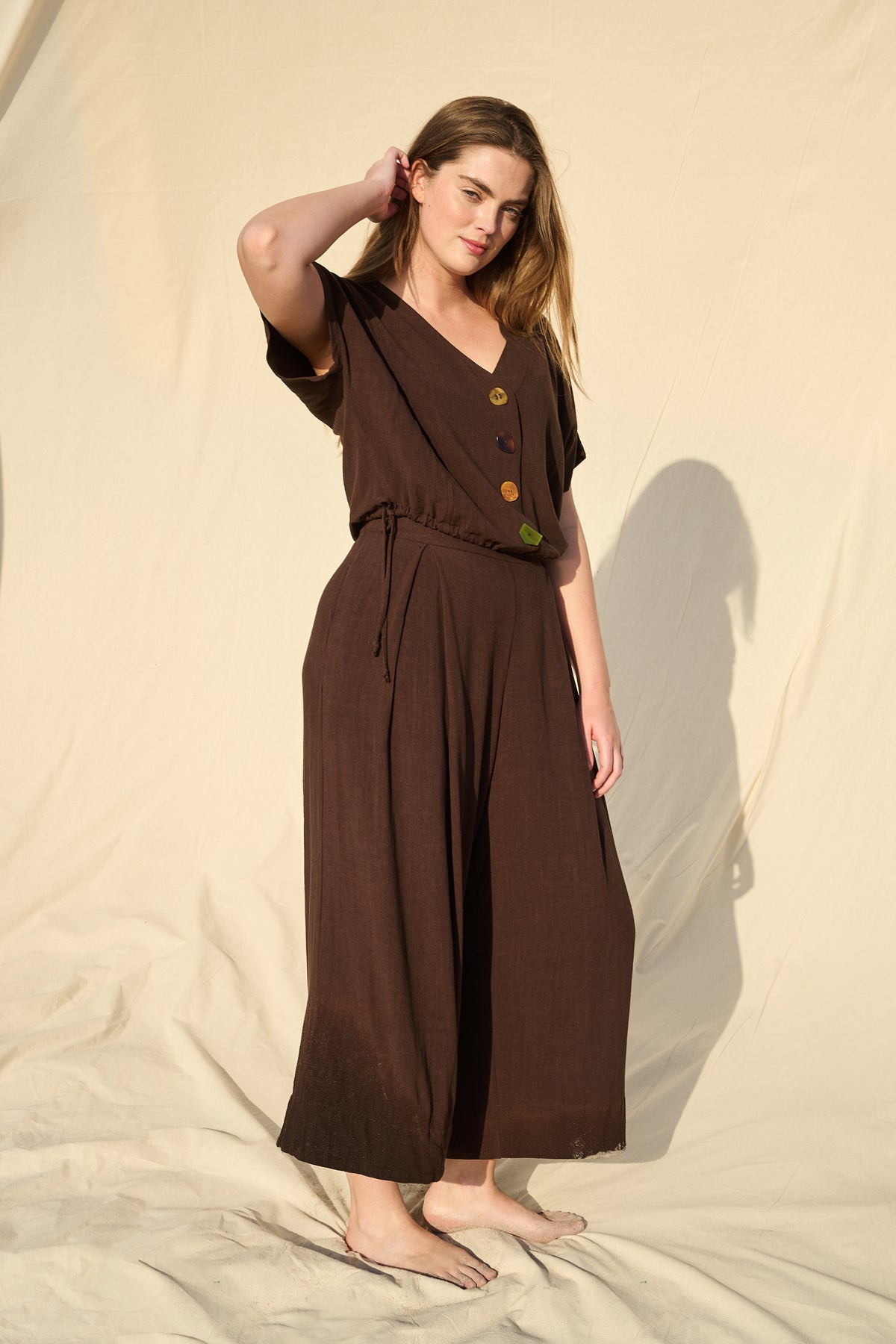 Model wearing chocolate rayon-linen top with drawstring waist