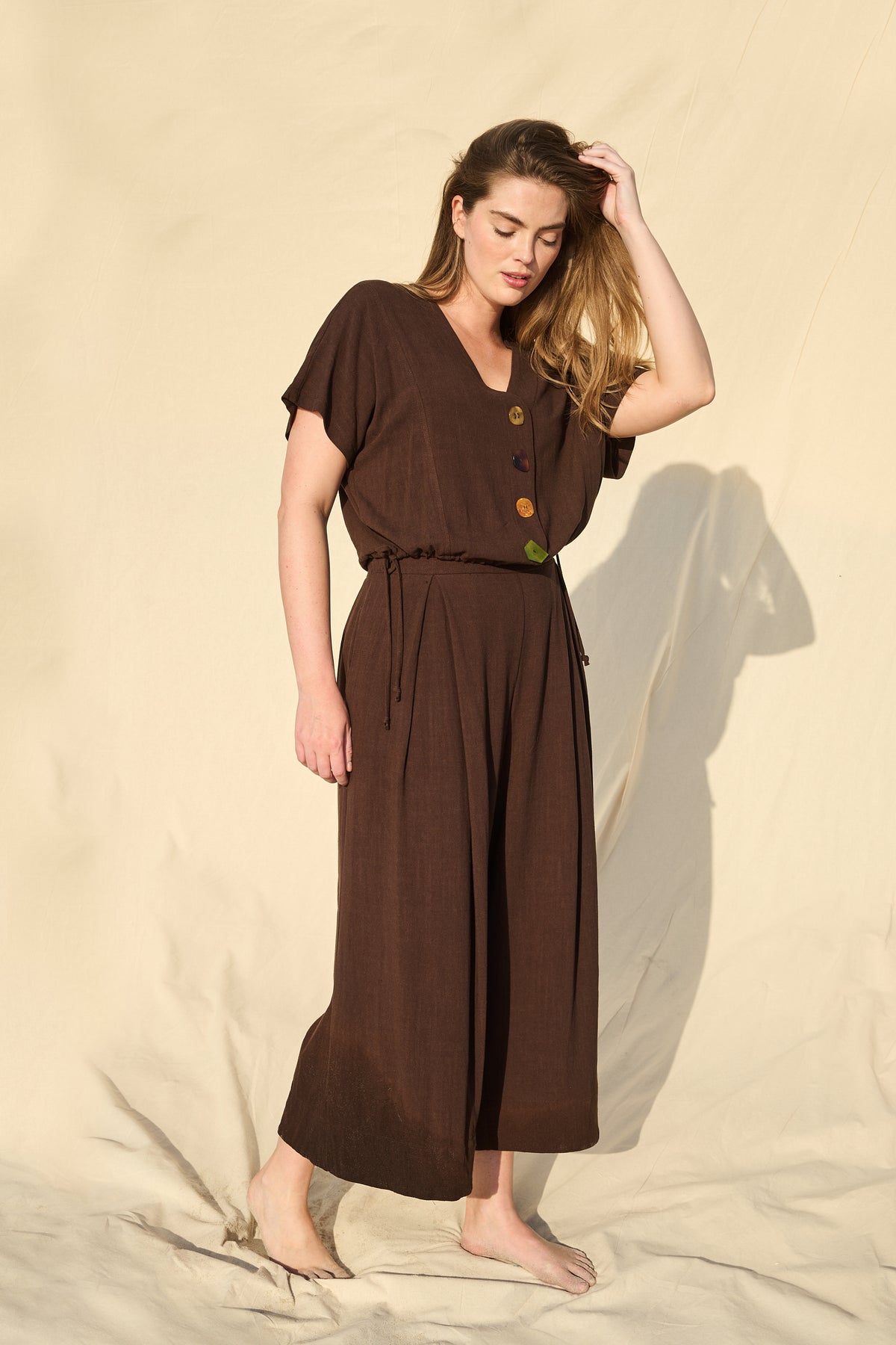Model wearing chocolate rayon-linen top with drawstring waist