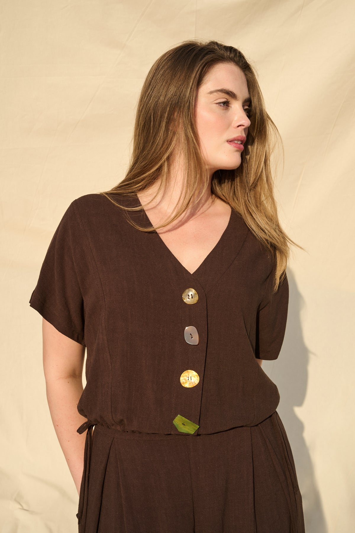 Model wearing chocolate rayon-linen top with drawstring waist