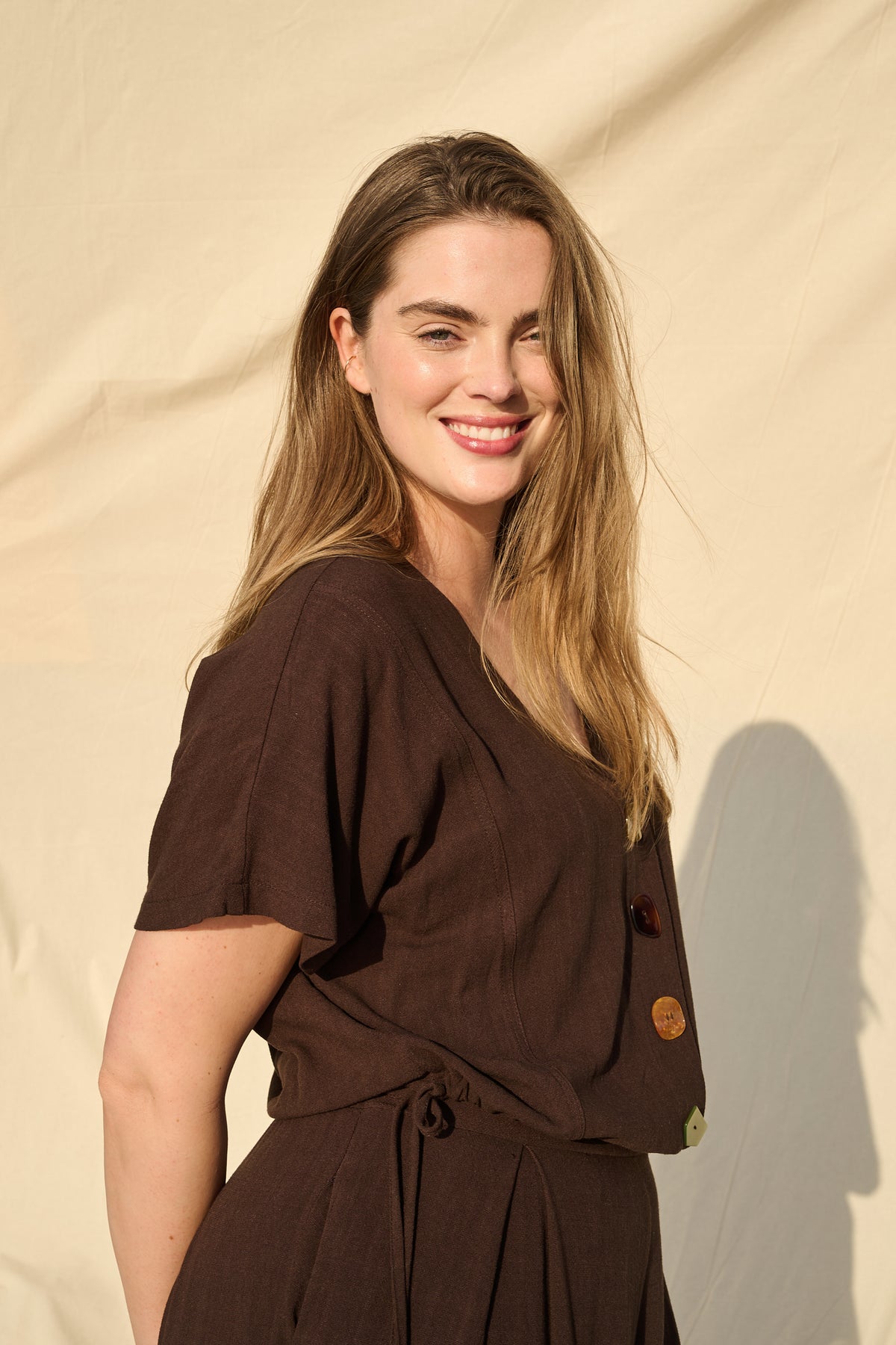 Model wearing chocolate rayon-linen top with drawstring waist