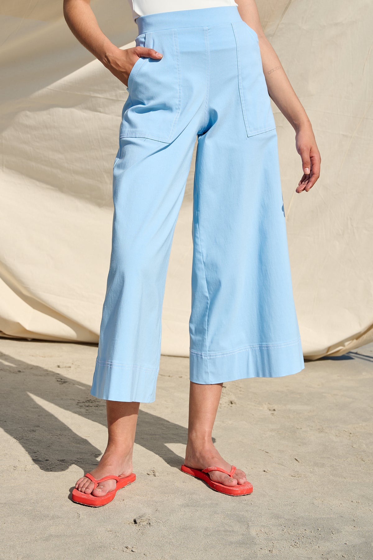 Light blue high-waisted wide-leg cropped pants with large patch pockets