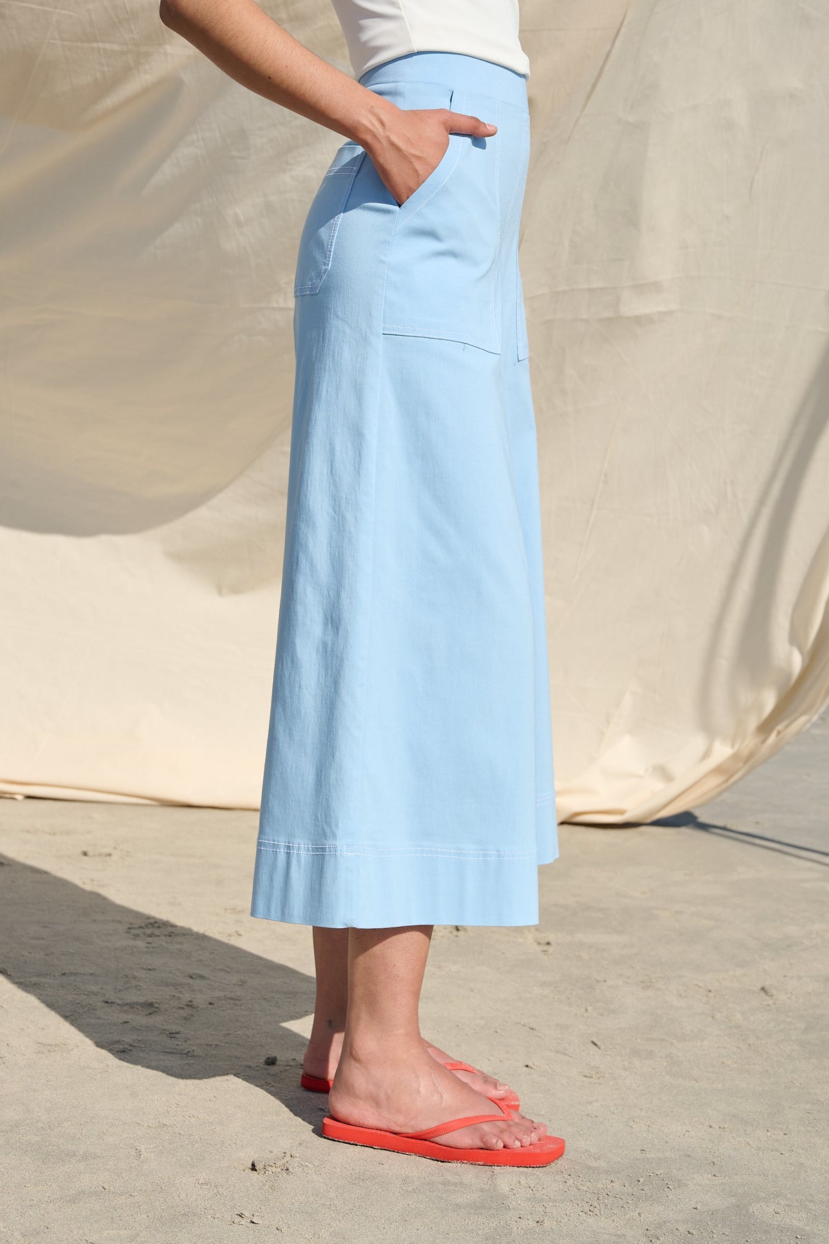 Light blue high-waisted wide-leg cropped pants with large patch pockets