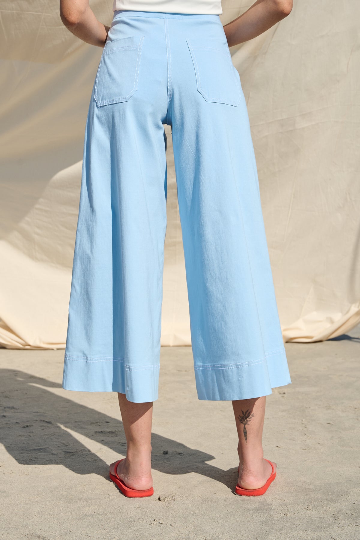 Light blue high-waisted wide-leg cropped pants with large patch pockets