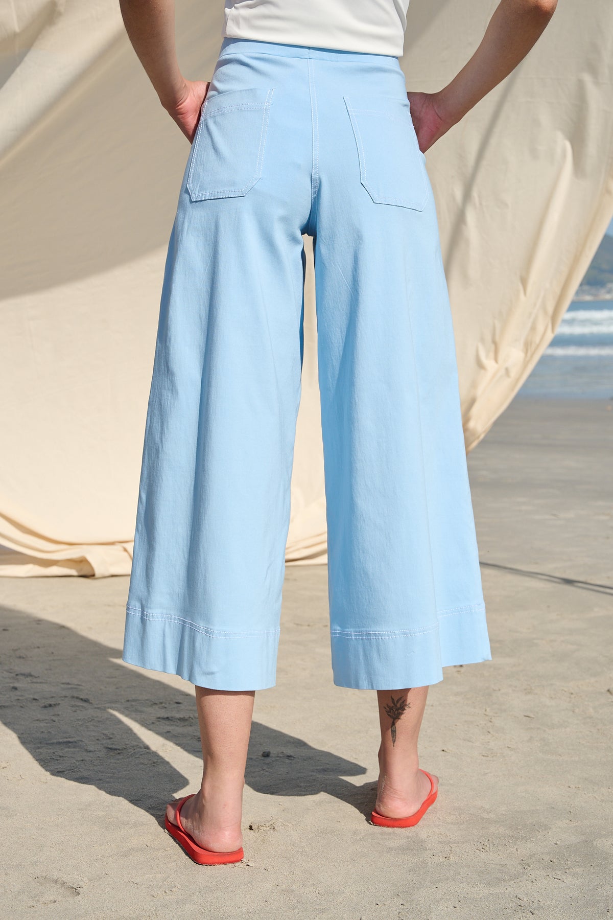 Light blue high-waisted wide-leg cropped pants with large patch pockets
