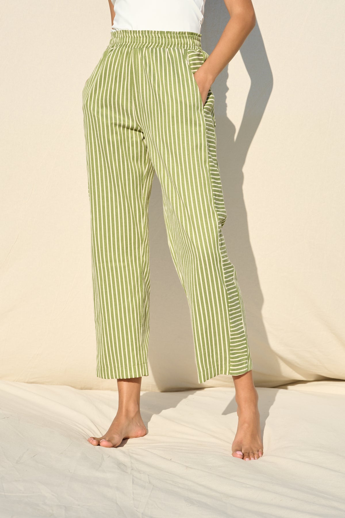 Green and white striped trousers with a relaxed, straight-leg fit
