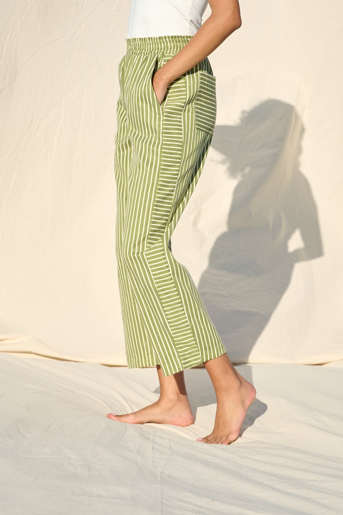 Green and white striped trousers with a relaxed, straight-leg fit