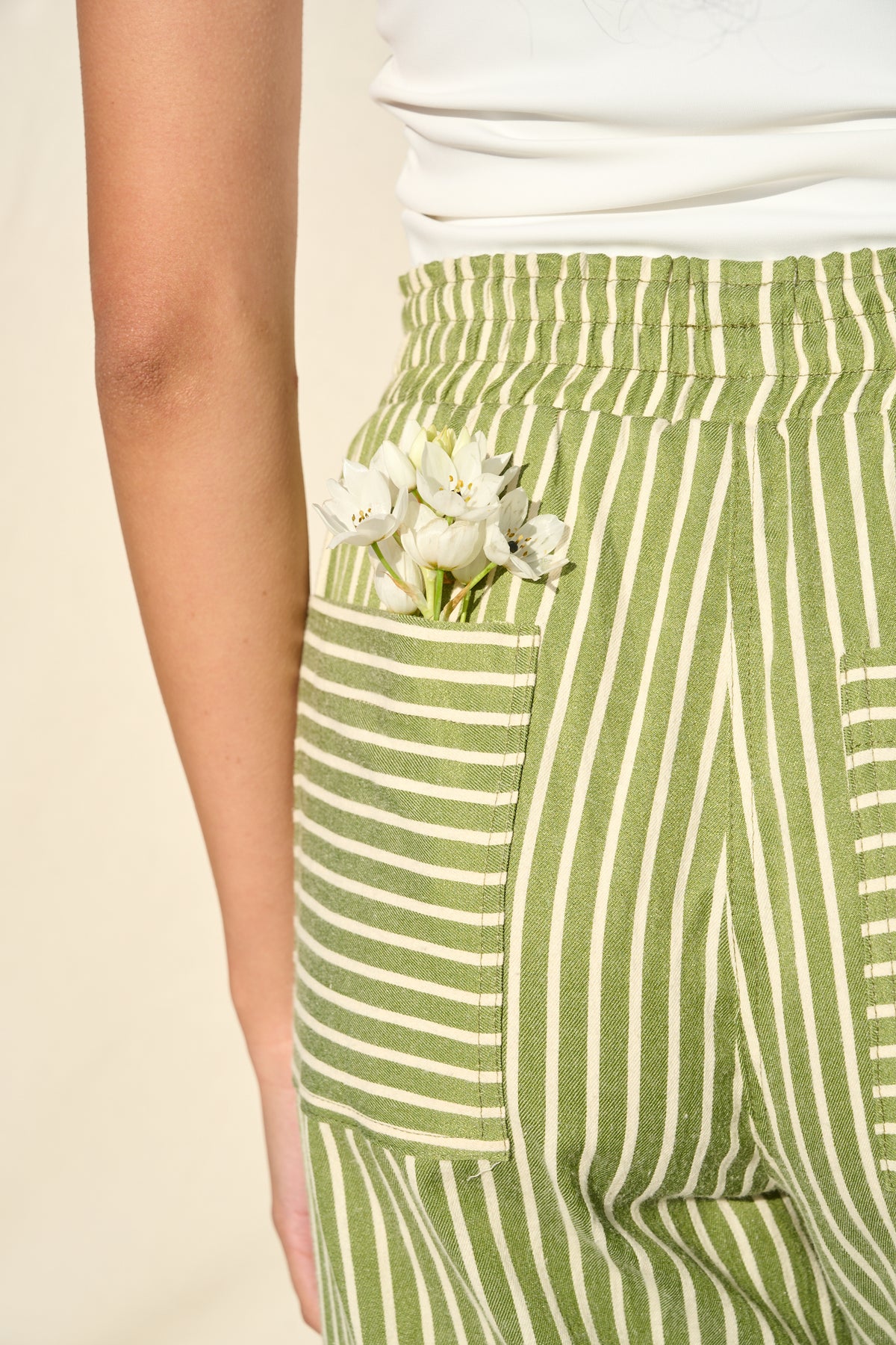 Green and white striped trousers with a relaxed, straight-leg fit