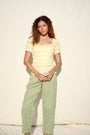 Green and white striped trousers with a relaxed, straight-leg fit