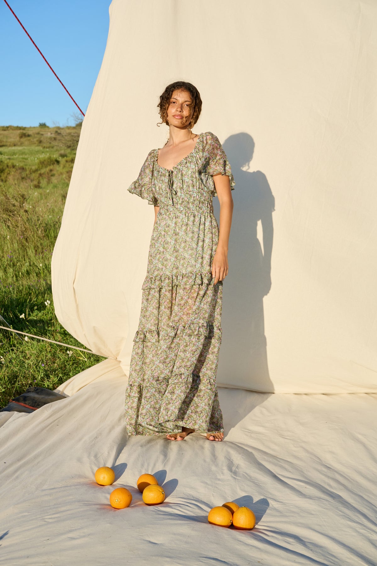 Pink and green floral maxi dress with flutter sleeves and tiered skirt