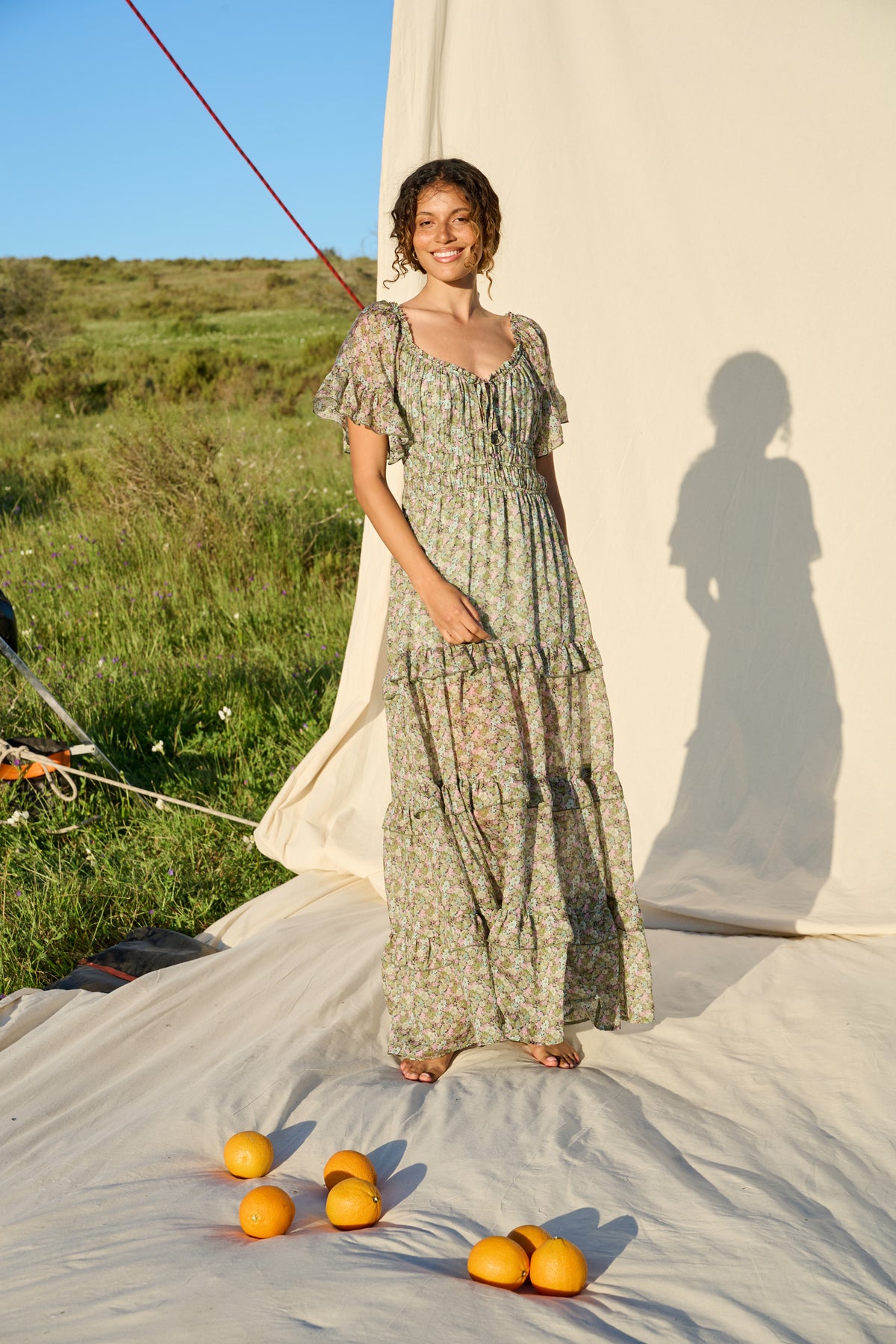 Pink and green floral maxi dress with flutter sleeves and tiered skirt