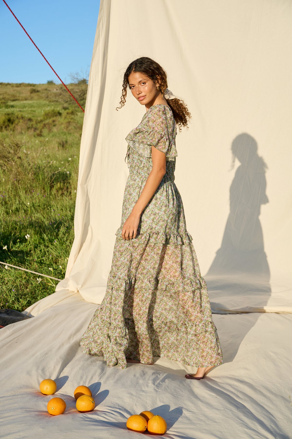 Pink and green floral maxi dress with flutter sleeves and tiered skirt