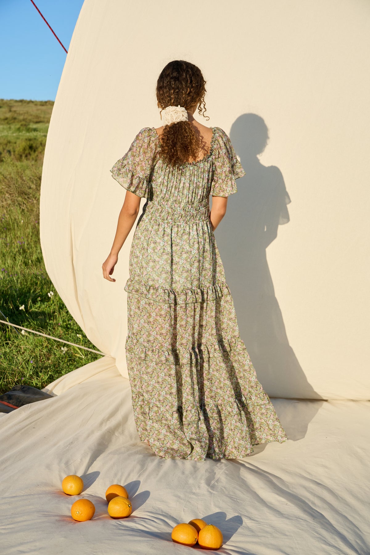 Pink and green floral maxi dress with flutter sleeves and tiered skirt