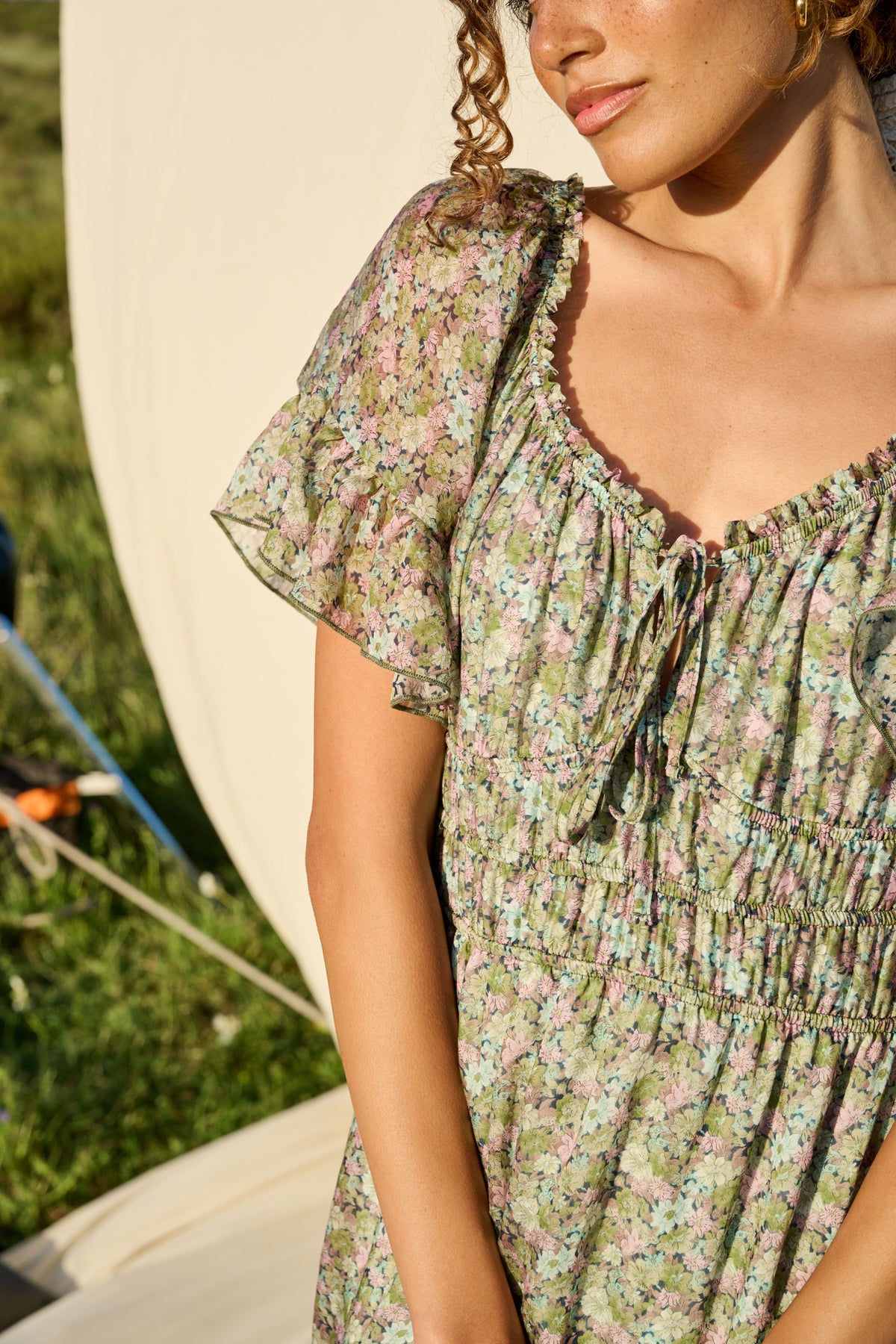 Pink and green floral maxi dress with flutter sleeves and tiered skirt