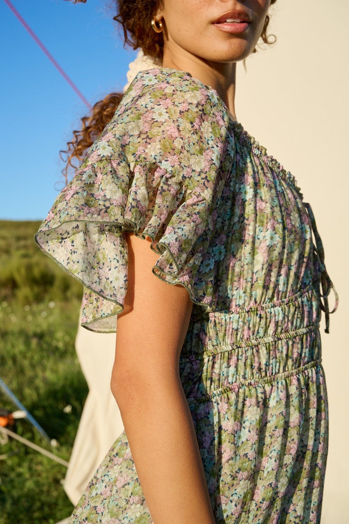 Pink and green floral maxi dress with flutter sleeves and tiered skirt