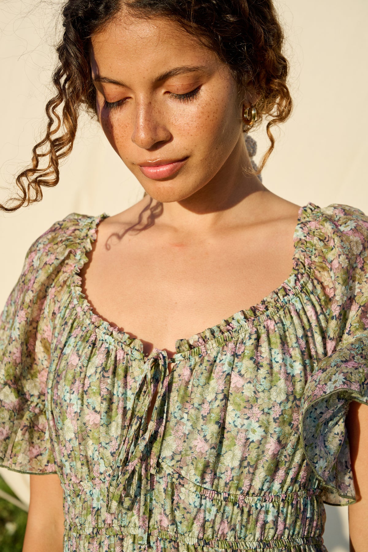 Pink and green floral maxi dress with flutter sleeves and tiered skirt