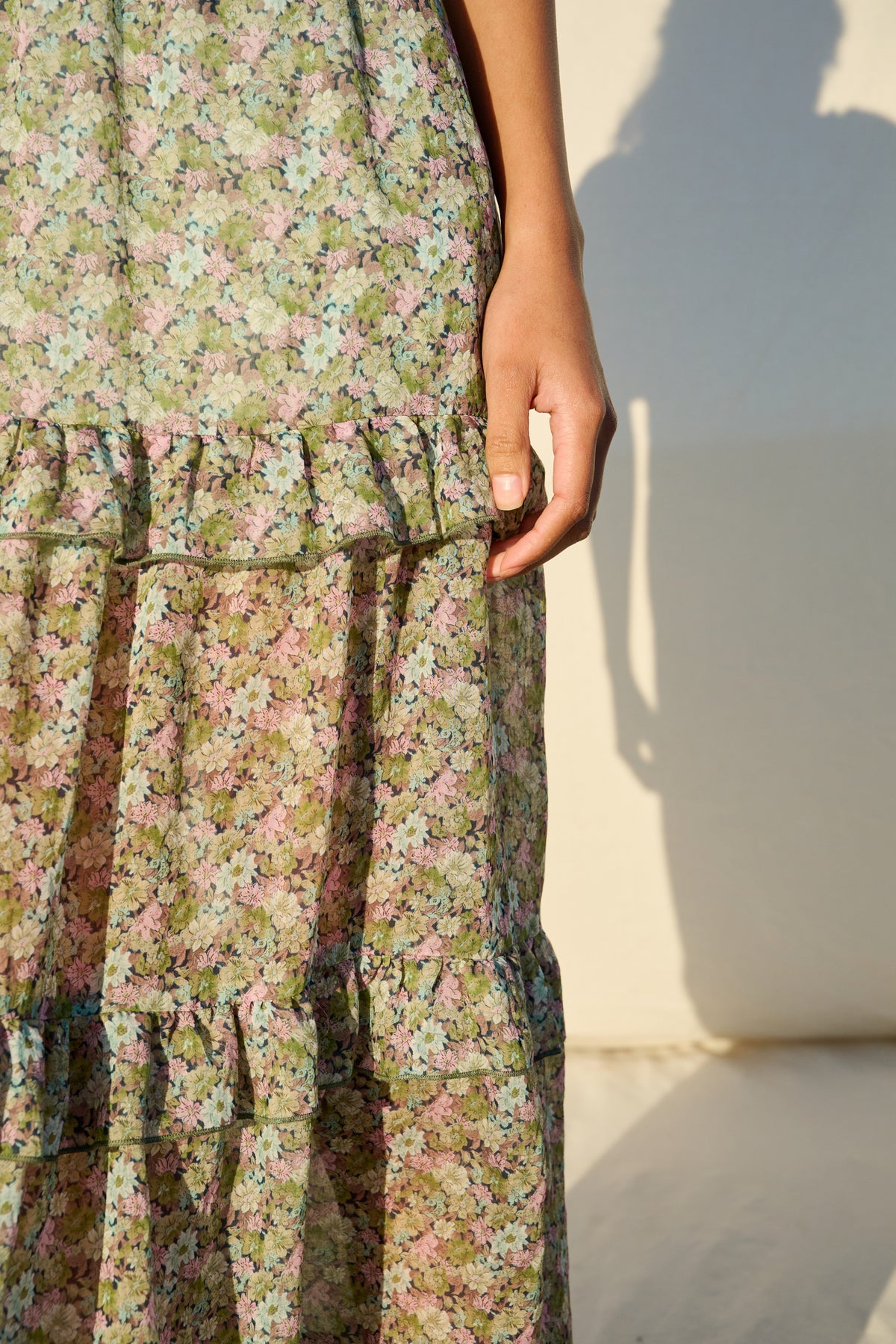 Pink and green floral maxi dress with flutter sleeves and tiered skirt