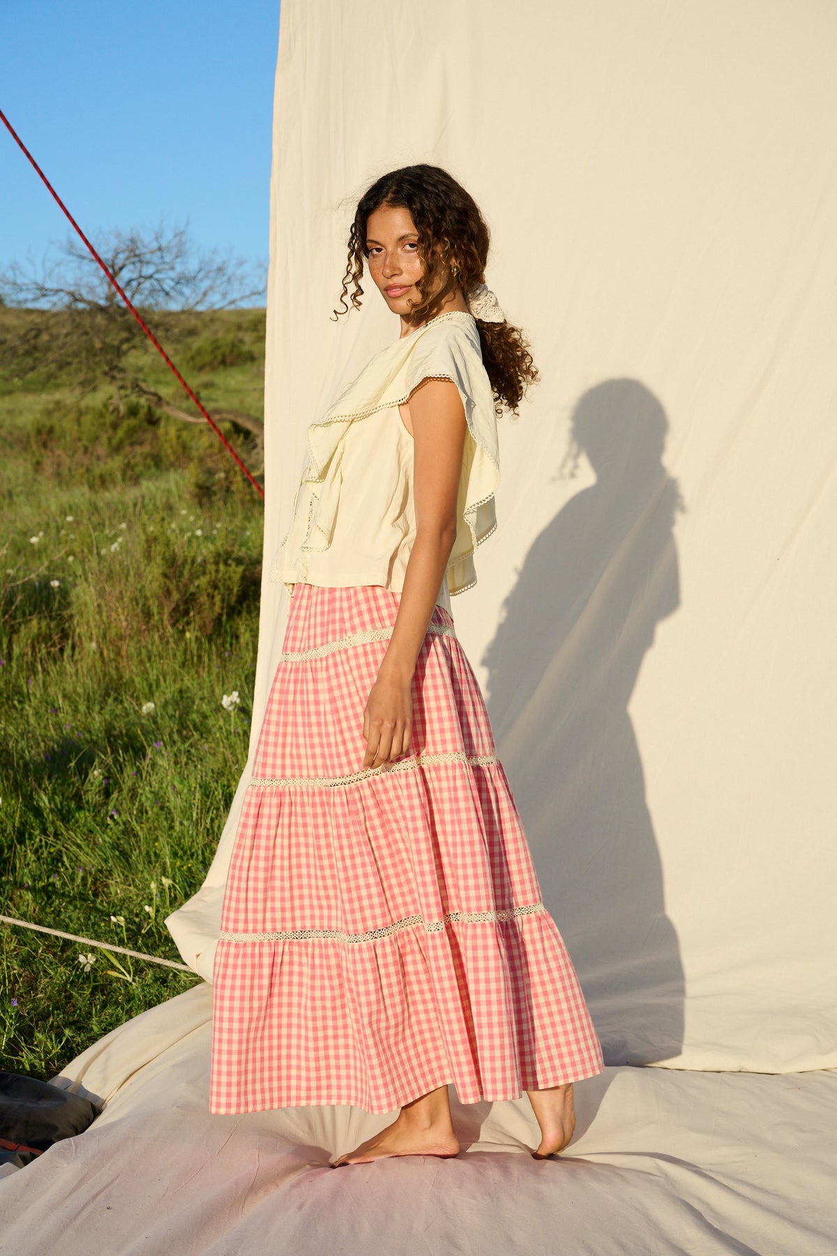 Butter yellow blouse with ruffle sleeves, lace trim and tie-front detail.