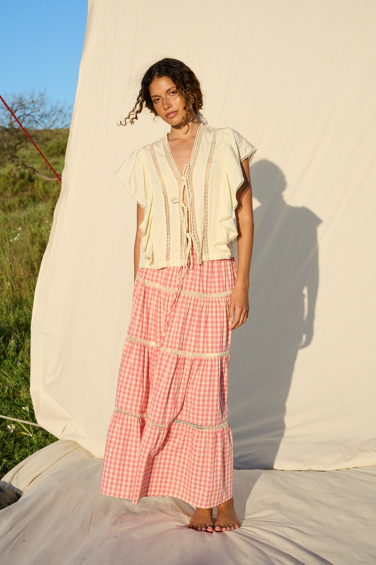 Pink gingham maxi skirt with lace trim and tiered ruffle detailing.