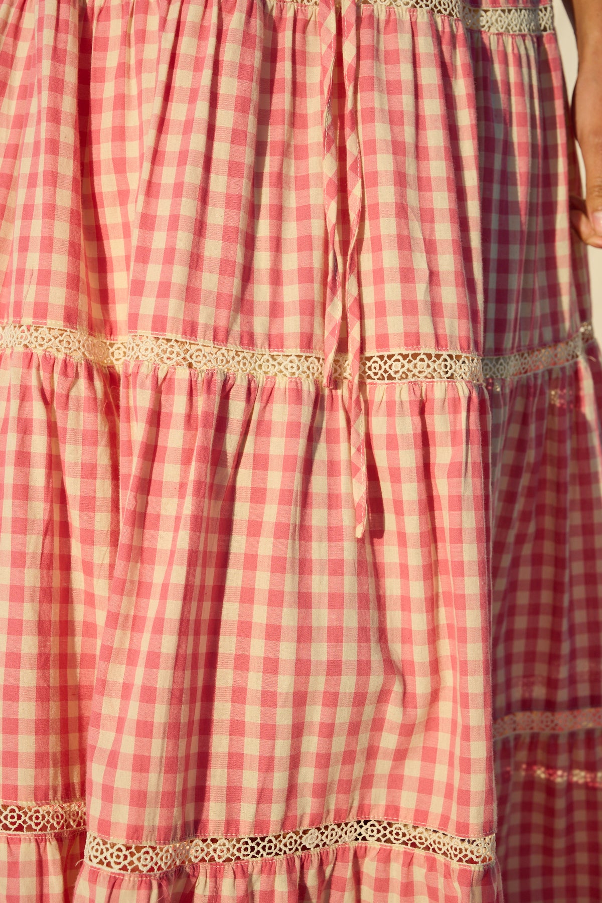 Pink gingham maxi skirt with lace trim and tiered ruffle detailing.