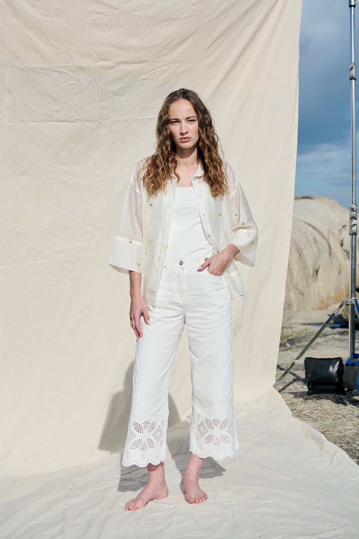 White cropped wide-leg jeans with broderie cutwork and scalloped hems